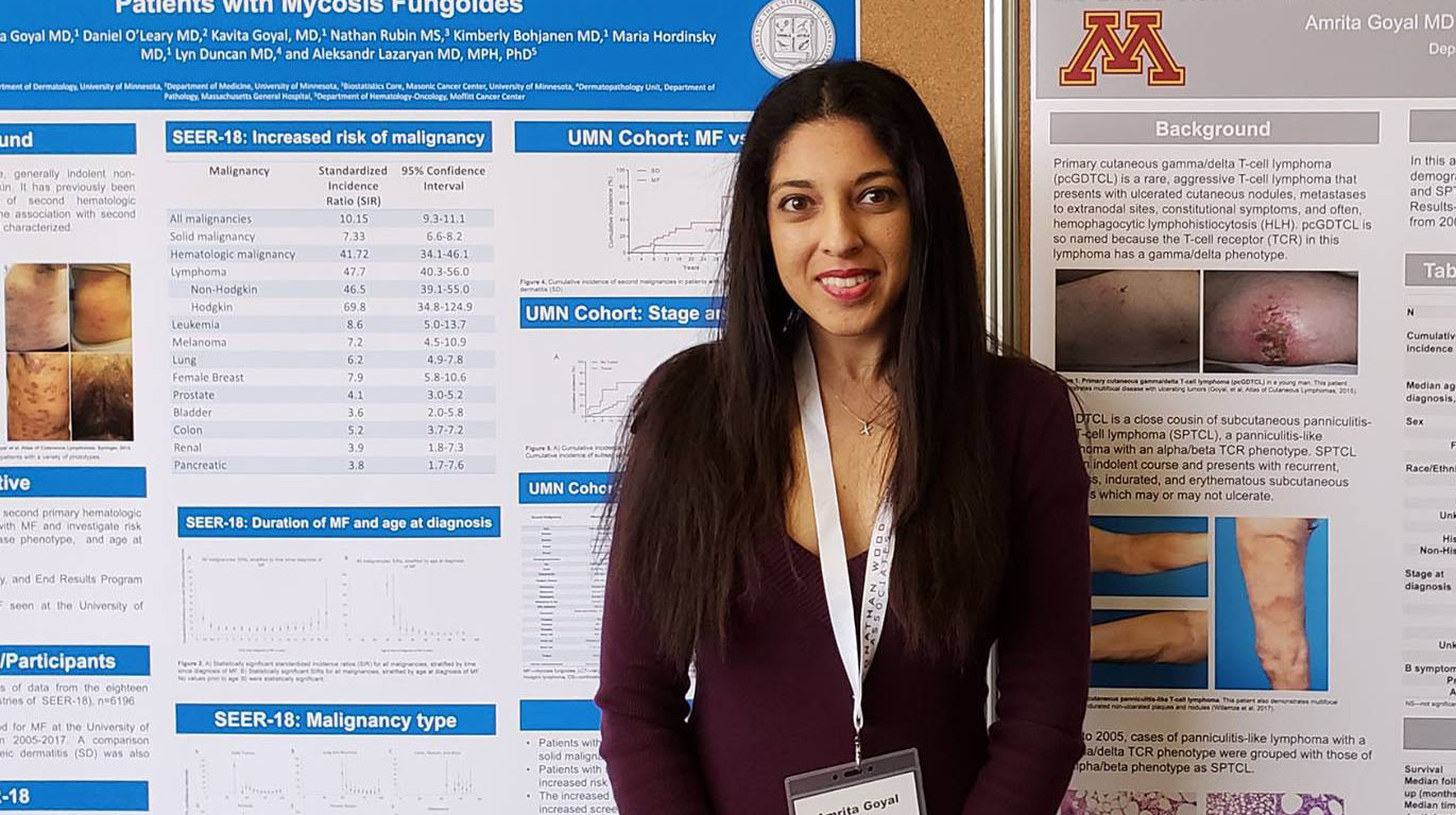 Dermatology trainee standing by research poster