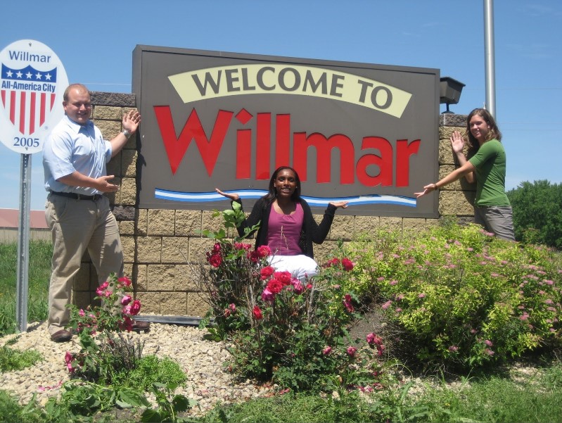 Posing with "Welcome to Willmar" sign