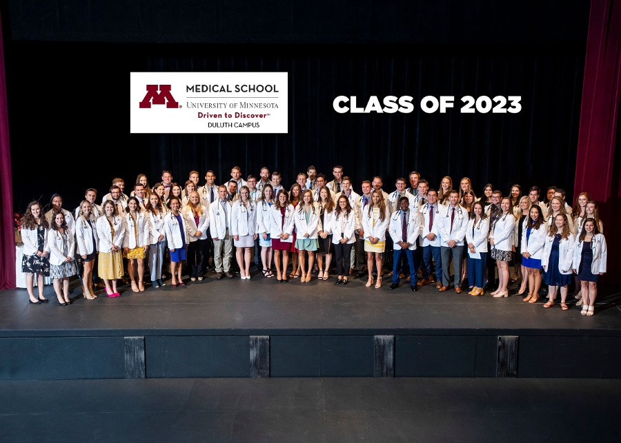 class of 2023 on stage after receiving their white coats
