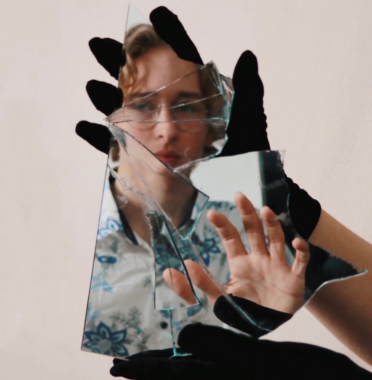 Girl holding a broken mirror