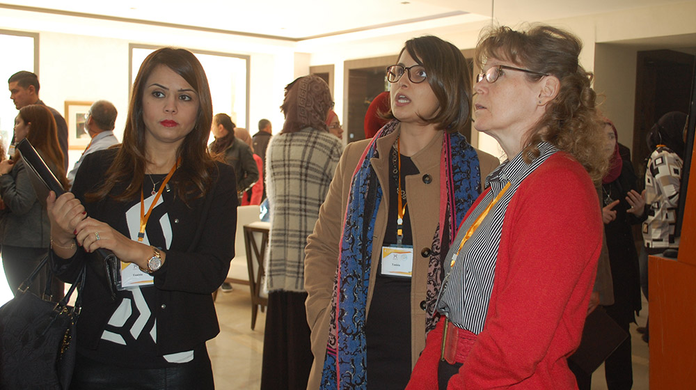 Three women viewing a presentation
