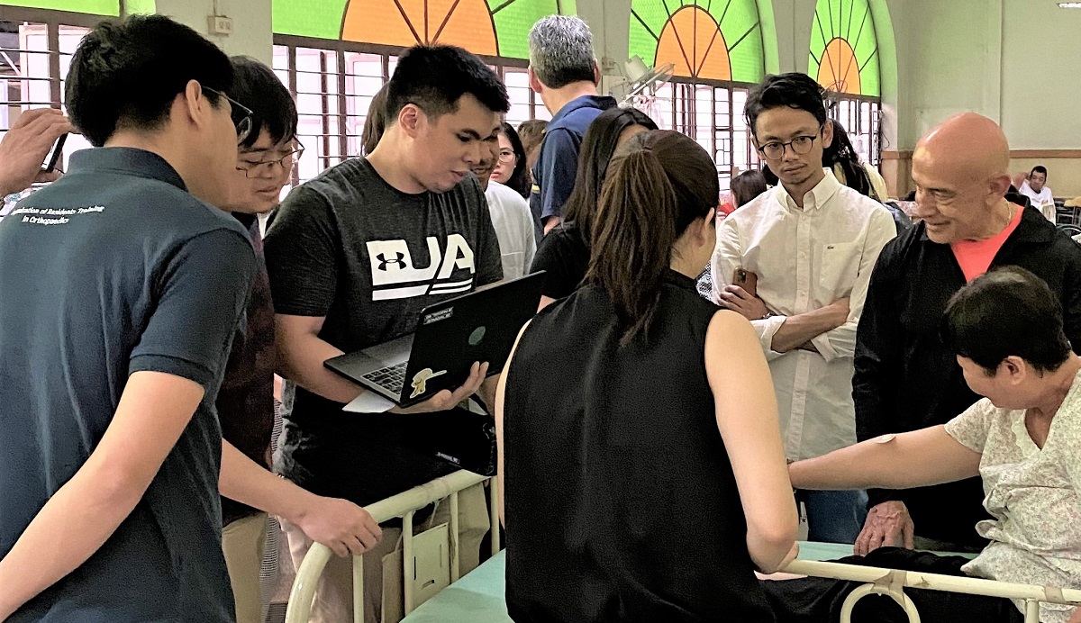 Dr. Diaz working with students in Manila