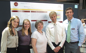 Dr. Anderson with students at a conference
