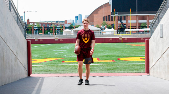 Young man standing in an entrance to TCF Bank field