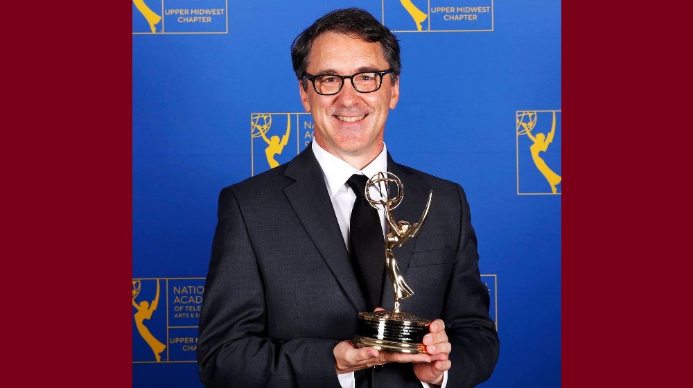 Dr. Jon Hallberg holding his Emmy Award