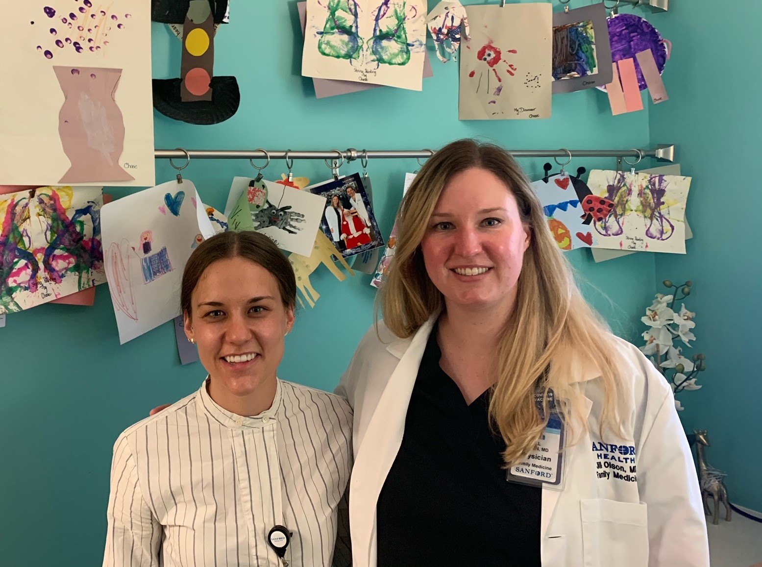 Student and preceptor in front of children's artwork