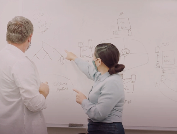 Doctors working with data on a white board