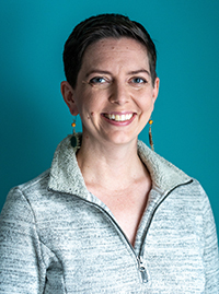 Kristina Krohn, MD, a smiling white woman against a teal background