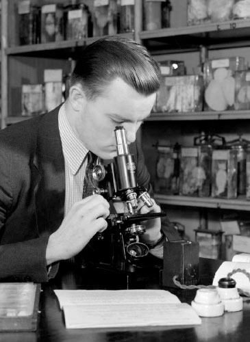 Historic photo of a man at a microscope