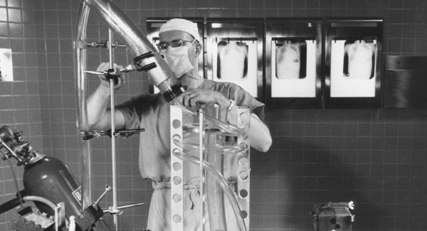 Historic photo of Richard DeWall, M.D., with his Lillehei-DeWall Bubble Oxygenator