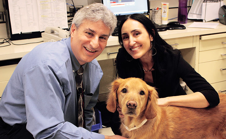 U veterinarians Jaime Modiano, V.M.D., Ph.D., and Antonella Borgatti, D.V.M., M.S., with patient Valky