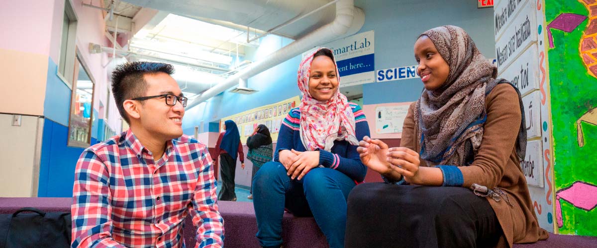 High school students Sabrina Ali  (middle) and Ramla Mohamud (right) ask their medical student mentor  Huy Donguyen about practical things like applying for scholarships and which classes to take to best prepare themselves for college.