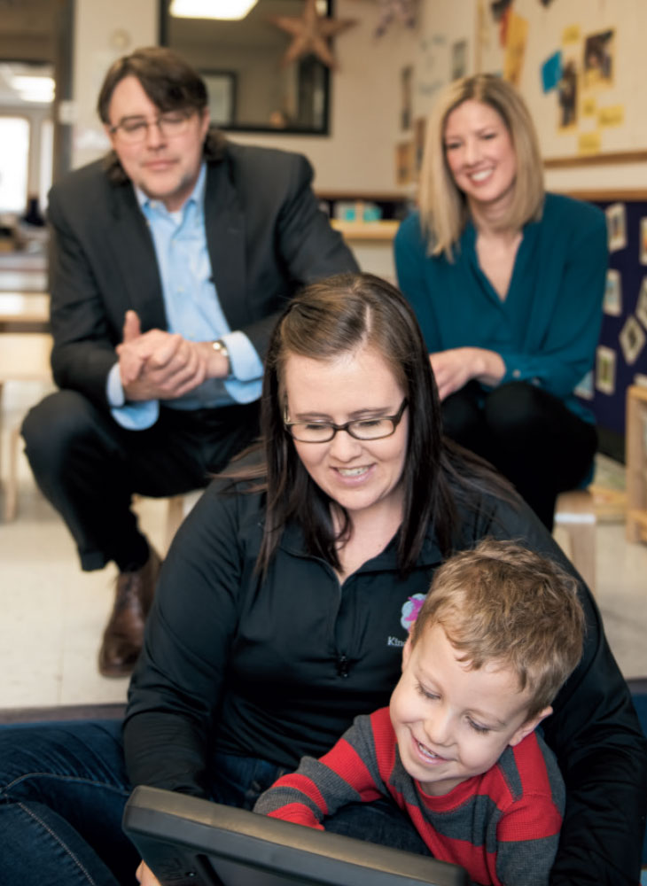 Philip Zelazo, Ph.D., and Stephanie Carlson, Ph.D., observe a child using their app aimed at assessing executive function.