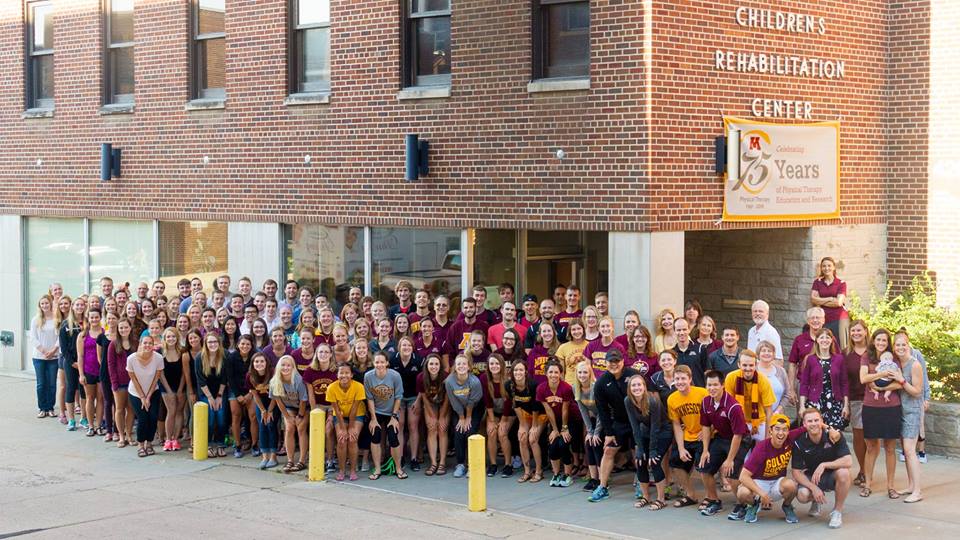 Group photo of physical therapy students outside building.