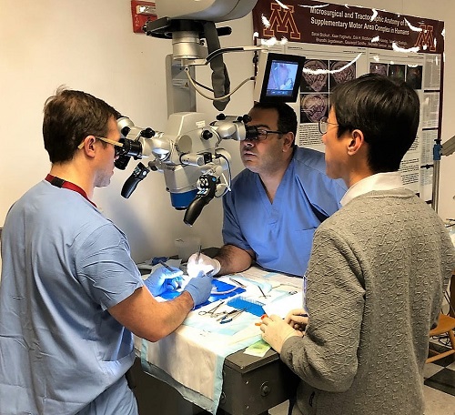 Coridon Quinn, IV, MD, performing a delicate microsurgery exercise under the watchful eye of instructor Junichi Yamamoto, MD