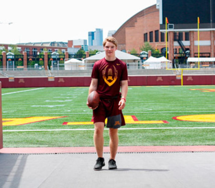 Young man standing in an entrance to TCF Bank field