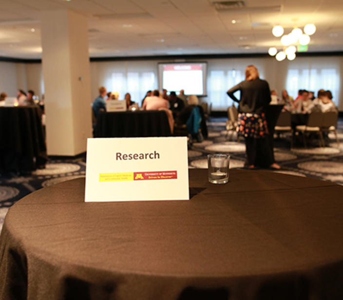 Conference with a table sign that has the word research on it