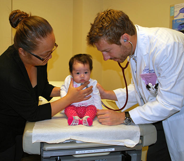 Woodwinds resident examining a child patient