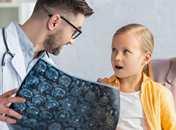 Radiologist looking at an image with a child