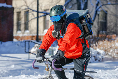 A cyclist in wintertime riding on the street