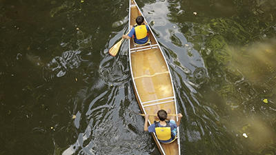 Two people in a canoe on a river