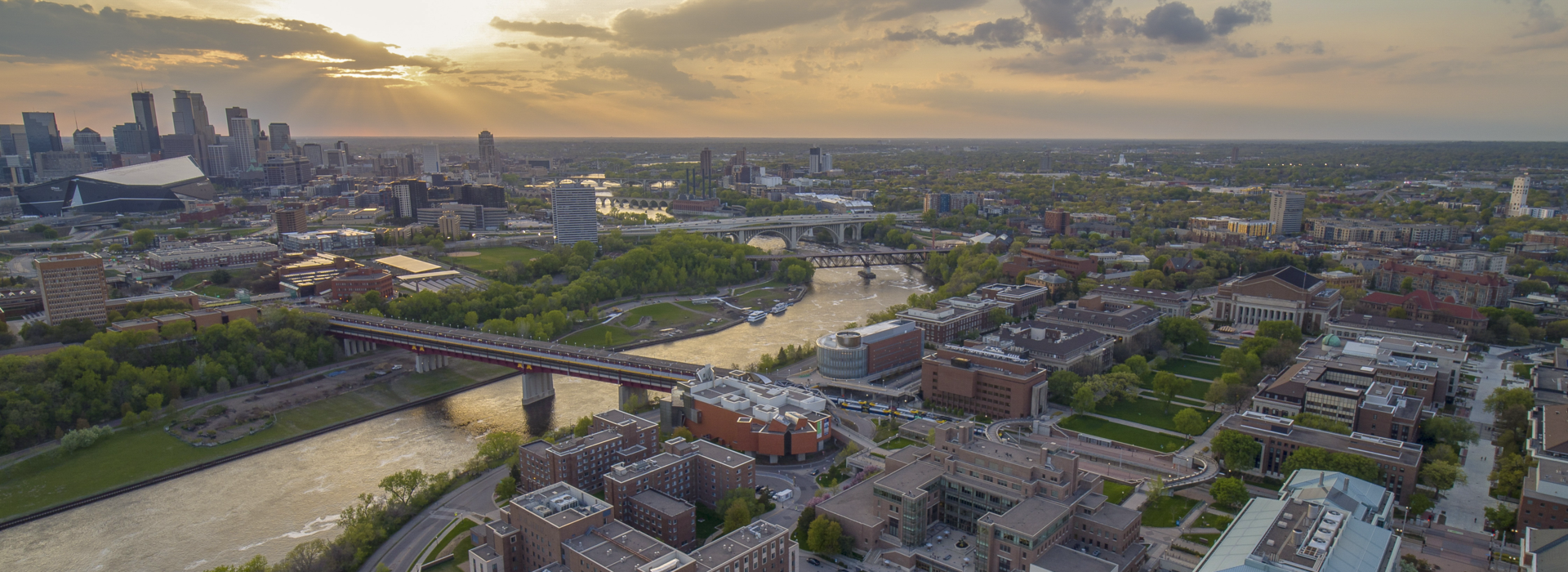 Bird's-eye view of the Minneapolis skyline, the Minnesota River, and the east and west banks of the UMN campus