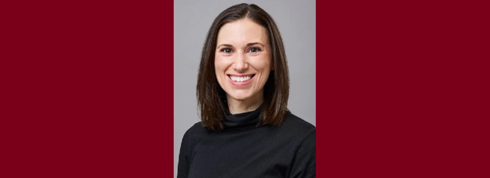 Portrait of Dr. Leah Henke against a maroon background.