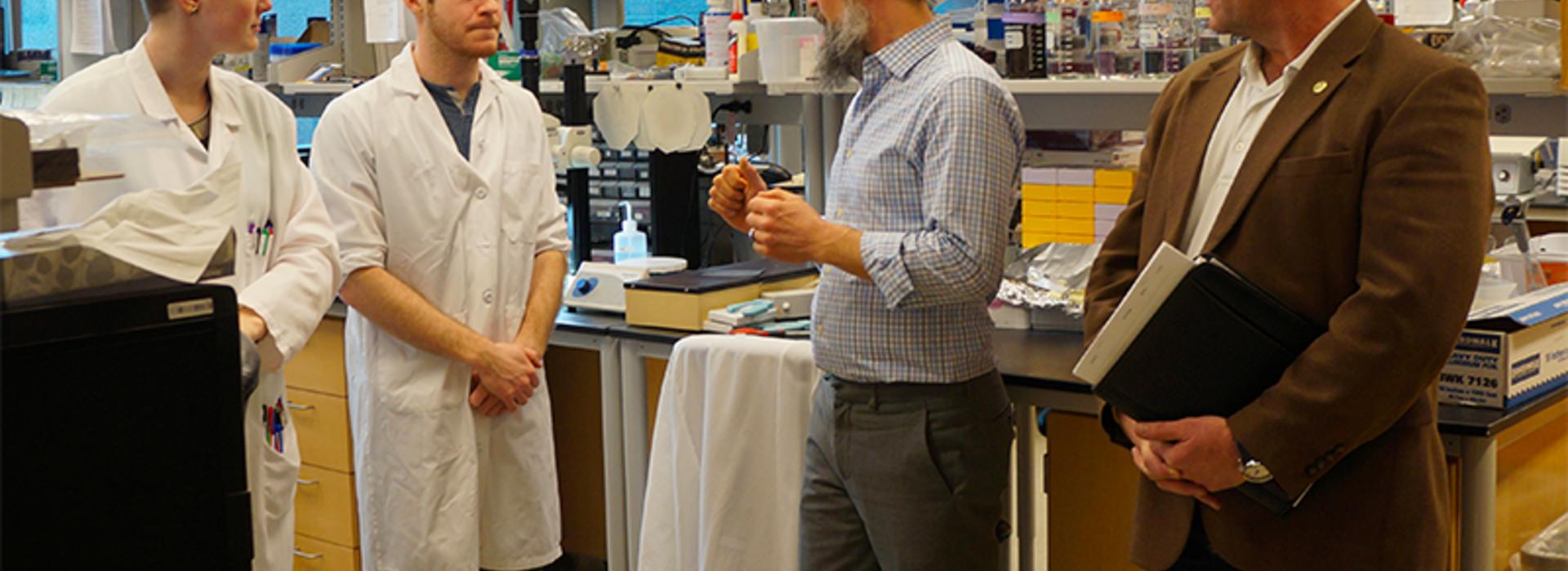 Representative Dave Baker touring a medical lab 