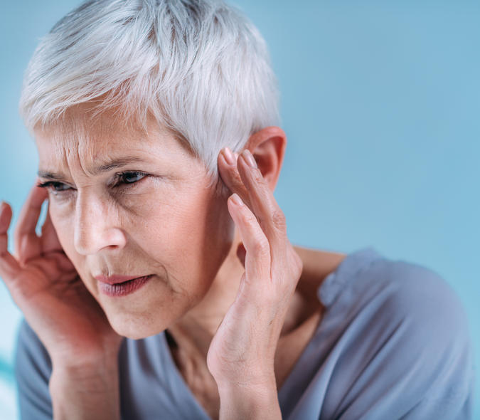 Woman suffering from tinnitus