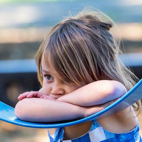 Girl resting head on swing