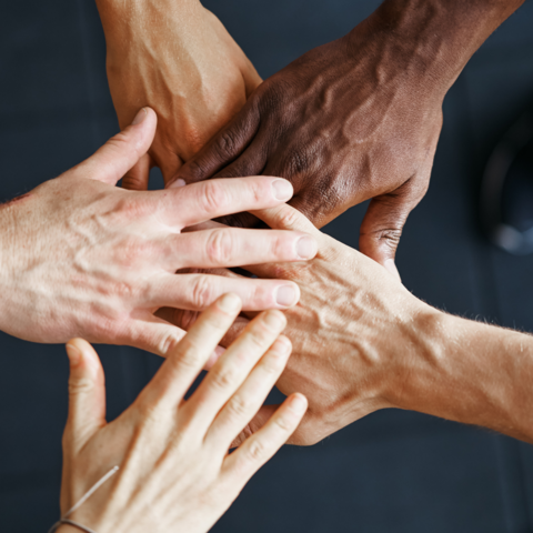 Hands joining together for article titled, Faculty-Student Partnerships Lead to Socially-Responsive Medical Education