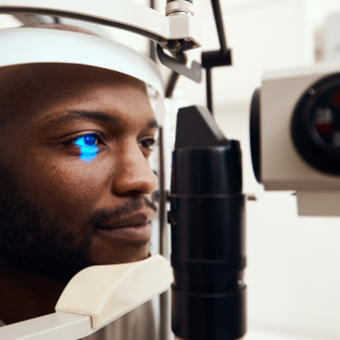 Shot of a young man getting his eyes examined with a slit lamp. Credit: Getty Images. 