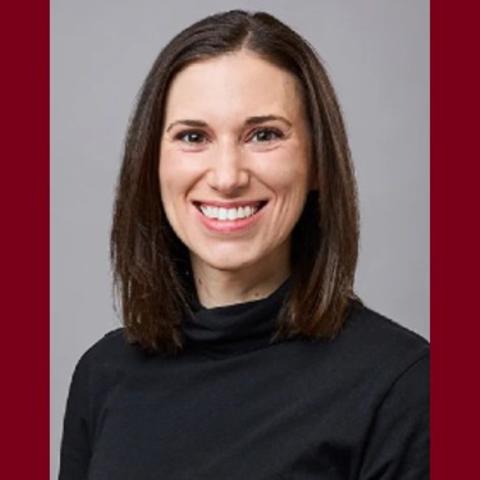 Portrait of Dr. Leah Henke against a maroon background.