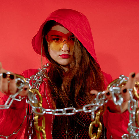 Carmen Aguirre in her video jockey gear, holding chains