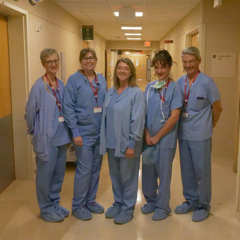 A group of medical technology professionals standing together.