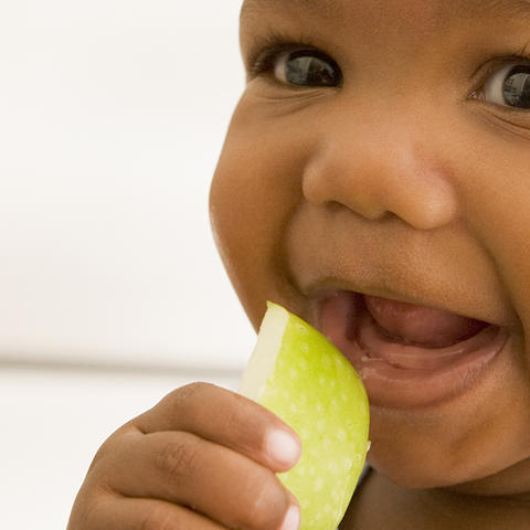 toddler eating an apple