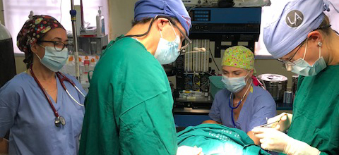 Surgeons and anesthesiologists performing surgery in Uganda
