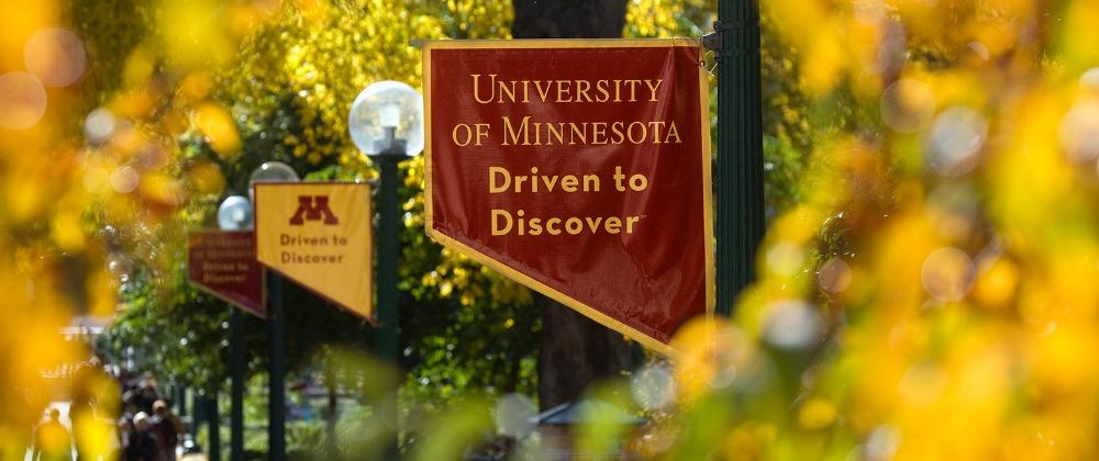 Banner hanging from lamp post that reads "University of Minnesota Drive to Discover"